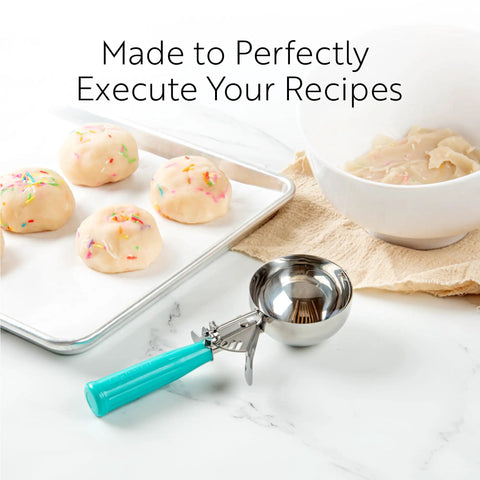 3.25 Ounce Trigger Release Portion Scoop With Green Handle Stainless Steel Disher for cookie dough near baking sheet