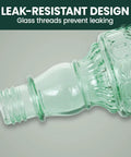 Close-up of the antique green glass bottle design of the Glass Bottle Hummingbird Feeder With Antique Green Finish, Four Flower Ports And Perches, 10 Fl Oz Nectar Capacity, Durable Brushed Nickel Base, Outdoor Garden Decor For Hanging From Tree, Porch Or Deck showing leak-resistant glass threads.