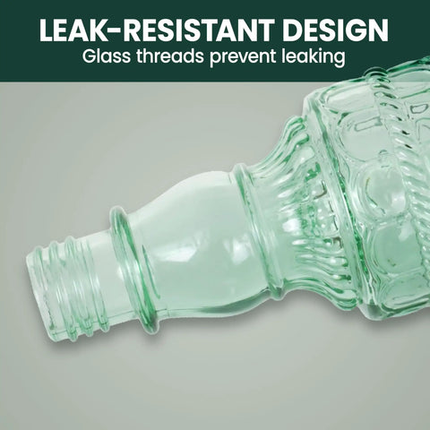 Close-up of the antique green glass bottle design of the Glass Bottle Hummingbird Feeder With Antique Green Finish, Four Flower Ports And Perches, 10 Fl Oz Nectar Capacity, Durable Brushed Nickel Base, Outdoor Garden Decor For Hanging From Tree, Porch Or Deck showing leak-resistant glass threads.