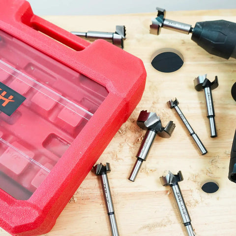 Pro Level 14 Piece Forstner Drill Bit Set Featuring Hella Sharp Carbide Tips And Rock Solid Alloy Steel Build on a wooden surface.