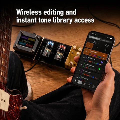 Musician using phone to control Tonex One Plus AI Guitar Amp And Effects Pedal with Bluetooth, shown on wooden floor.