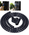Spiral Cable Wrap For Home Office And Entertainment Centers With Clamp shown in black, coiled with wire sleeve and clamp attachment.