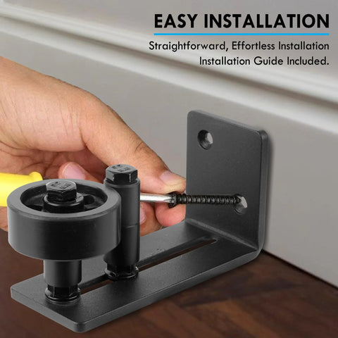 Sliding Barn Door Floor Guide With Bottom Adjustable Roller Eight Setup Options Delivers Quiet Operation And A Flush Design With Felt Strips Prevents Door From Swinging Or Hitting Walls Ensures Perfect Alignment Easy Installation Pack Of One is being installed on a floor surface.