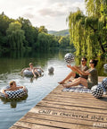 Checkered Race Car Inflatable Pool Toy Set, Includes 2 Oversized 22.8 Inch Swim Rings And 6 Large 16 Inch Beach Balls by a lake