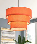 Orange Plug In Pendant Light With Three Tier Mid Century Modern Linen Shades hanging in a stylish living room setting.