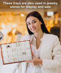 Top Tier Wooden Jewelry Organizer Tray With Plush Velvet Grids And Quick Swap Dividers For Earrings Necklaces And Pendants Keep Your Stash Sorted In This Slick Drawer Display Setup Gray held by a smiling woman in a jewelry store.