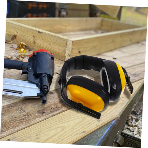 Lock Down Every Distraction Heavy Duty Noise Reduction Earmuffs on a workbench with a nail gun, ideal for industrial use.