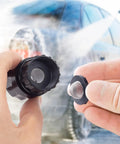 Hands holding a 20 Pack Stainless Steel Hose Filter Washers With Screen Inlet Strainer For 3/4 Inch Garden Hose Connector And 5/8 Inch Washing Machine with a blurred car wash background.