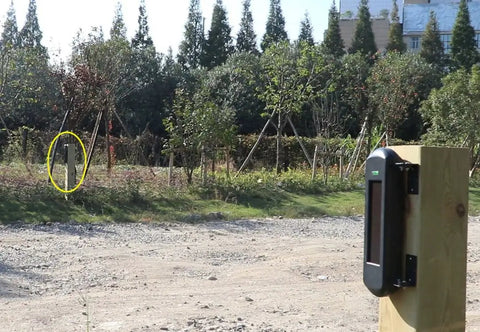 Solar Wireless Outdoor Driveway Alarm Sensor With 3 Beam Photoelectric Detection IP66 Waterproof installed on post in yard