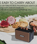 Aroma Mini 5W Guitar Amp With Clean And Overdrive Channels AG 04 on a picnic setup outdoors