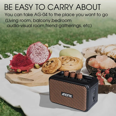 Aroma Mini 5W Guitar Amp With Clean And Overdrive Channels AG 04 on a picnic setup outdoors