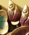 Close-up of handcrafted solid wood wall mount coat rack with gold and red floral designs for entryway organization.