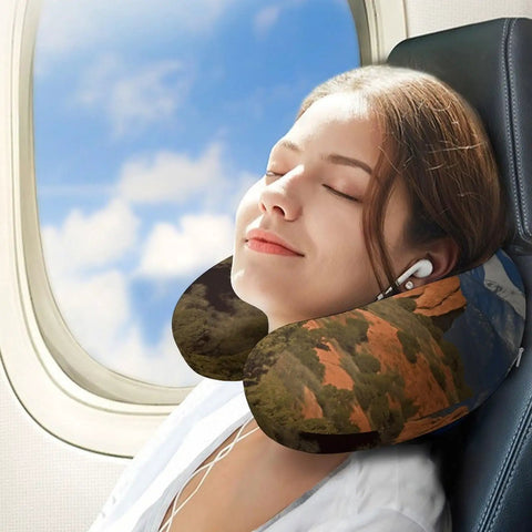Woman using Pikes Peak Colorado Travel Pillow U Shaped Neck Support for Long Haul Flights and Office Naps on airplane seat