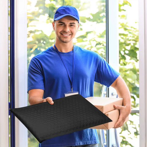Courier holding 10 Point 5X16 Inch Bubble Mailers 40 Pack Self Seal Padded Envelopes, waterproof black cushioning mailers in hand