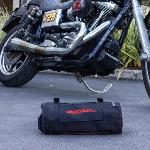 Ride Ready 48 Piece Motorcycle Tool Kit in a compact roll up next to a Harley Davidson V Twin bike on a driveway