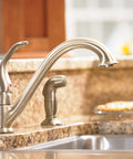 Single-Handle Low Arc Kitchen Faucet In Slick Chrome Finish With Easy Temperature Control installed on granite countertop
