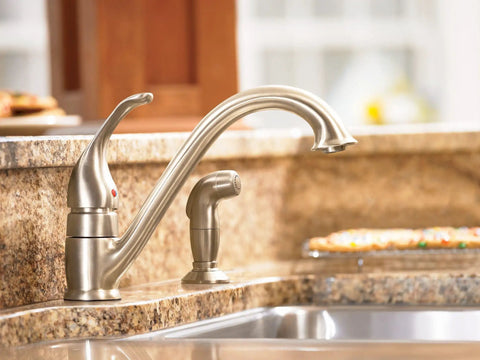 Single-Handle Low Arc Kitchen Faucet In Slick Chrome Finish With Easy Temperature Control installed on granite countertop