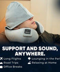 Person wearing Wireless Bluetooth Music Neck Pillow With Hood For Travel Sleep Semicircular Design With Built In Speaker in lounge