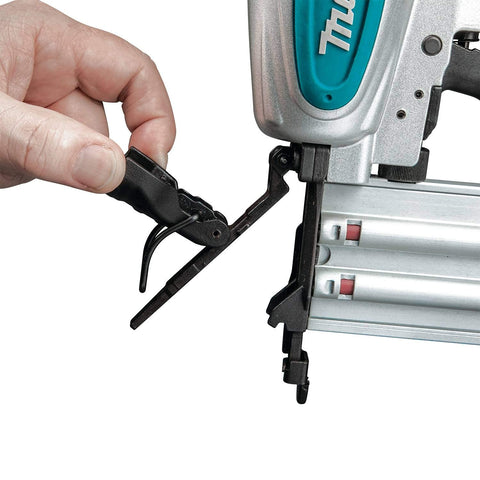 A hand adjusts the depth control on a Renewed 18 Gauge Pneumatic Brad Nailer For DIY Pros, showing narrow nose and aluminum body.