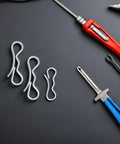 Beefy Bow Tie Cotter Pin And Heavy Duty Deck Clip Fasteners Kit with tools on black background