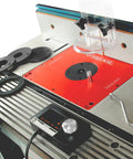 Motorized Router Lift For 3 5 Inch Routers Featuring Digital Controller Micro Adjustment Five Insert Rings And Cnc Aluminum Plate mounted on router table.