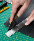 Round Leather Knife For Cutting, Trimming, Skiving And Shaping Pro Grade High Carbon Steel Blade being used on leather sheet