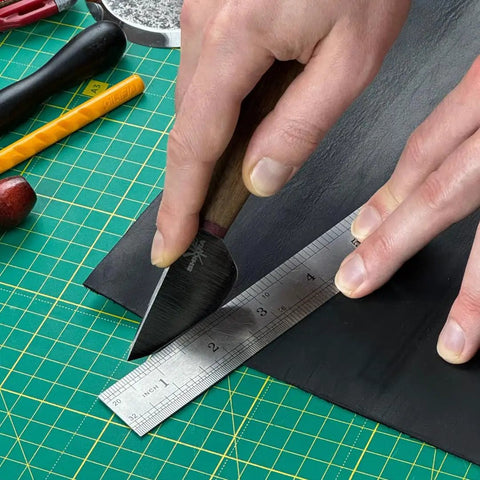 Round Leather Knife For Cutting, Trimming, Skiving And Shaping Pro Grade High Carbon Steel Blade being used on leather sheet