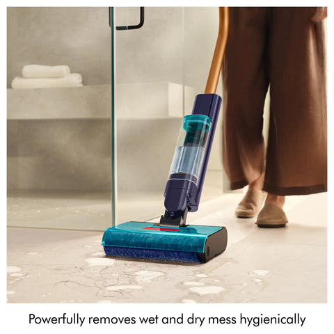 Person using Clean And Wash Hygiene Wet And Dry Hard Floor Cleaner for spills and stains on a tiled floor.
