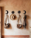 Solid As A Rock Vintage Cast Iron Sun Moon Wall Hooks Heavy Duty decorative hangers hold bags and hats on a wall.