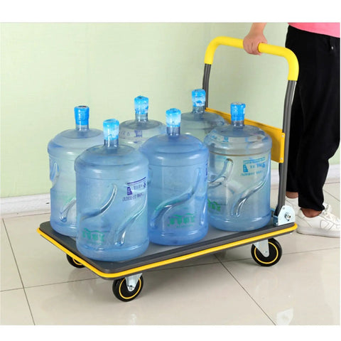 Heavy Duty Foldable Platform Cart With Self Balancing Frame And Glides Like Butter For Sweatless Warehouse Hauling And Driveway Moves Up To Six Hundred Sixty Pound Capacity loaded with six water jugs.