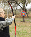 Archer aiming at Portable 20 Inch Round Straw Archery Target, 4 Inch Thick, Lightweight Handmade Solid Straw Target With Deep Red Finish