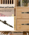 Antique Bronze Cabinet Pulls 6.88 Inch Zinc Alloy Wardrobe Drawer Handles, carved hardware installed on wooden cupboard.