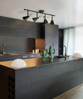 Dope Lofty Industrial Four Light Track Lighting Fixture With Pivoting Heads In Matte Black And Brass Accents installed in modern kitchen