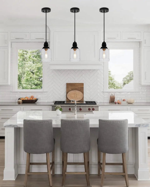 Slick Five Point Five Inch Seeded Glass Mini Pendant Light Featuring Badass Black Metal Hanging Fixtures for Kitchen Island and Dining Room above kitchen island.
