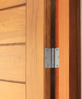 Interior door hinge, 3.5 x 3.5 inches, satin nickel finish, heavy-duty steel, installed on a wooden door.