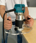 Clear Acrylic Router Base Plate Optimized For Rt0701c And Xtr01z Routers with hands gripping, ready for precision cuts.