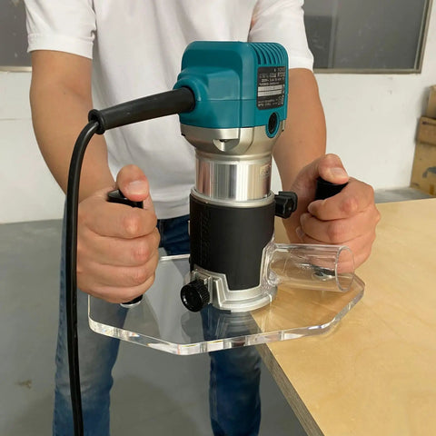 Clear Acrylic Router Base Plate Optimized For Rt0701c And Xtr01z Routers with hands gripping, ready for precision cuts.