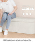 Person sitting on Go To Storage Ottoman With Cozy Sherpa Lining For Living Room Foldable Foot Rest Bench 43.3 Inch, 330 lbs capacity.