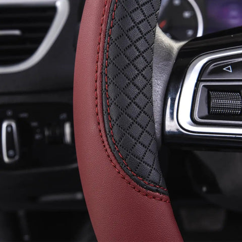 Close-up of Rhombus Microfiber Leather Steering Wheel Cover Universal Fit For Car Suv Truck Van With Padded Sides And Slick Grip In Black And Burgundy.