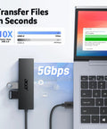 Four Port USB 3.0 Hub With 5Gbps Transfer, Laptop And PC Extender, connected to laptop displaying file transfer speed.