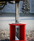 Magnetic RV Jack Stabilizer Blocks Four Pack, Fold Flat leveling pad in red supporting trailer jack.