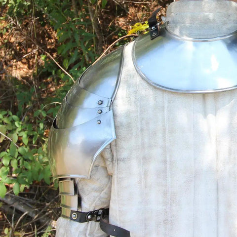 Medieval 18 Gauge Steel Avenger Pauldrons Set With Genuine Leather Straps And Neck Harness displayed on a mannequin outdoors.