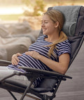 Woman relaxing on a chair with Cozy Recliner Pillow Neck Support Headrest Cushion For Travel And Home Office Relaxation Pain Relief.