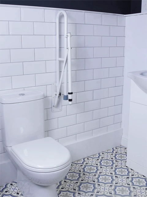 Heavy Duty Stainless Steel Toilet Safety Rails Featuring A Foolproof Flip Up Mechanism With Sturdy Leg Support For Secure Bathroom Access And Comfortable Shower Assistance mounted beside a toilet.