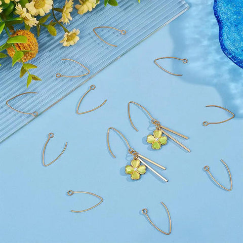 Golden V Shape Stainless Steel Earring Hooks, 50 Pcs Metal Ear Wires With Horizontal Loop For Jewelry Making DIY Earrings Findings displayed on a blue surface with decorative elements.