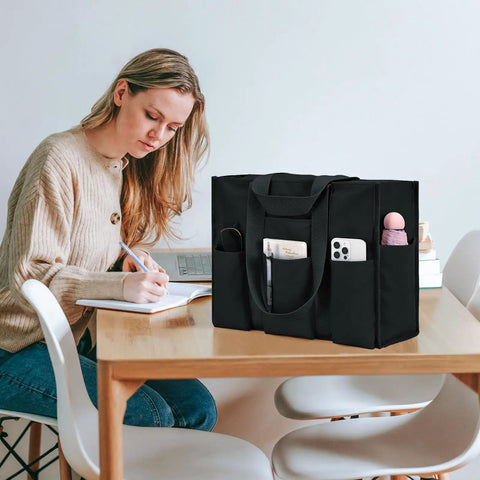 Woman studying at a table with Ultra Large Waterproof Tote Bag For Women With 12 Pockets And Top Zipper Closure beside her.