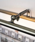 Adjustable 14 Inch LED Picture Light 4W Antique Brass Finish 3000K with decorative hinge, close-up of mounting detail.