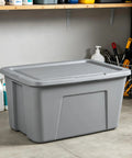 Kickass 30 Gallon Heavy Duty Plastic Storage Bin With Secure Snap Lid For Garage Organization Seasonal Gear Sorting And Everyday Essentials In Matte Gray Finish in a garage setting.