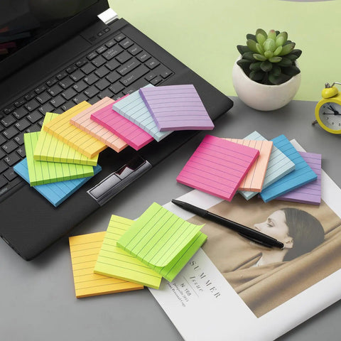 Lined Sticky Notes 3x3 Inches, 16 Pack With 56 Sheets Per Pad, Super Sticky Adhesive, shown on a desk with a laptop and plants