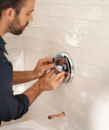 Man installing MPact PosiTemp Pressure Balancing Tub And Shower Valve With IPS Half Inch Connections Four Port Brass Valve Kit